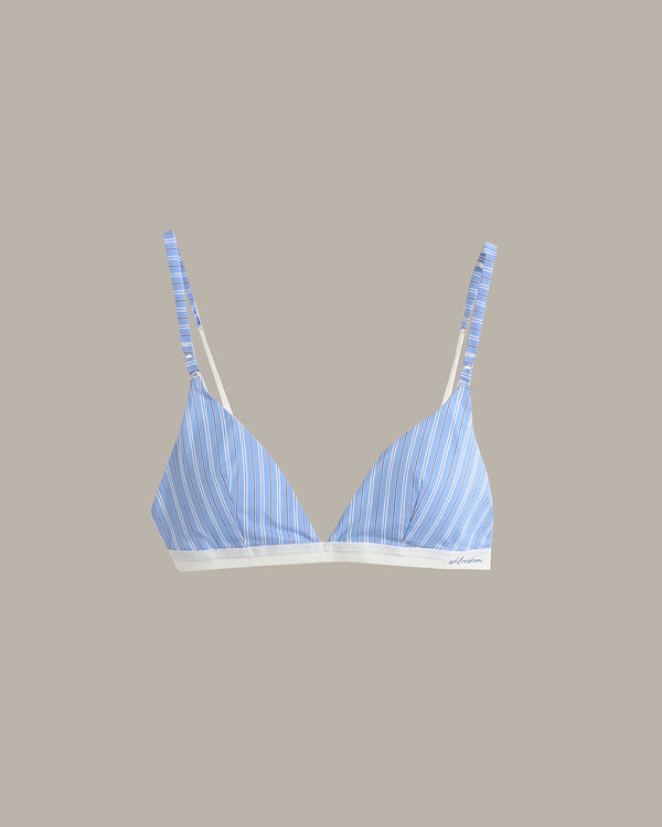 A light blue and white striped triangle bralette with thin adjustable straps and a white underband, shown against a solid taupe background.