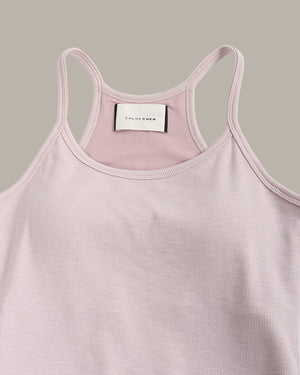 Pink tank top with a visible brand label on a gray background