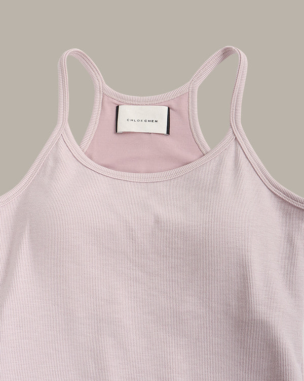 Pink tank top with a visible brand label on a gray background