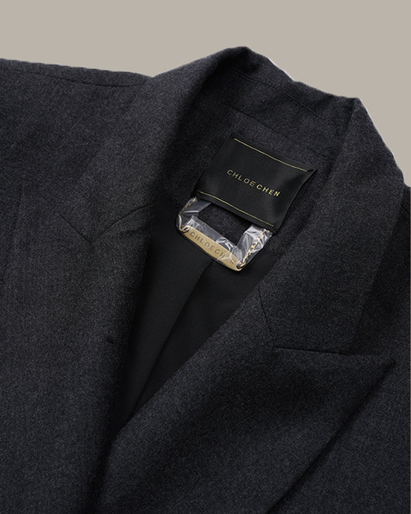 Close-up of a dark charcoal gray wool-blend blazer by Chloé Choker, showing the inner collar with a black brand label and a gold metal size tag.