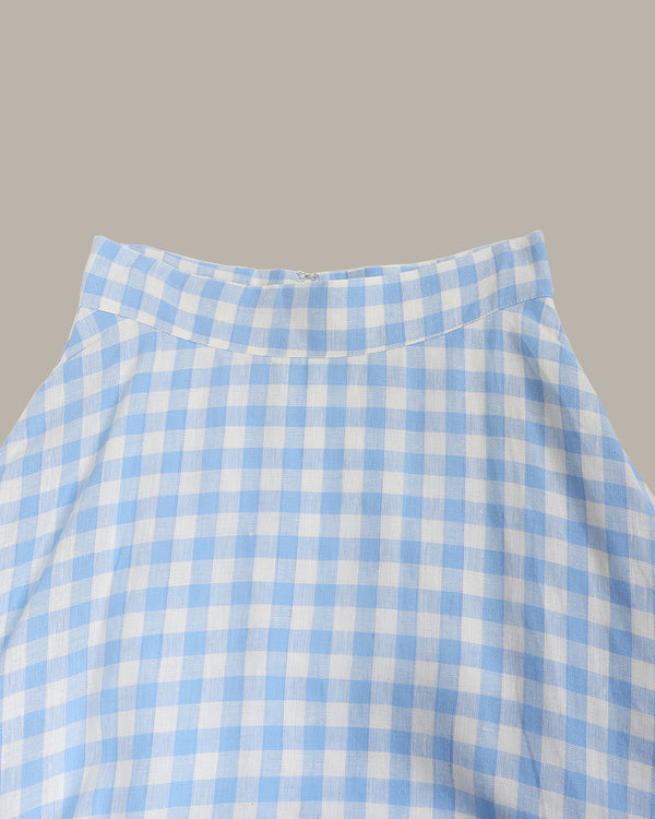 Close-up of a blue and white checkered fabric on a gray background