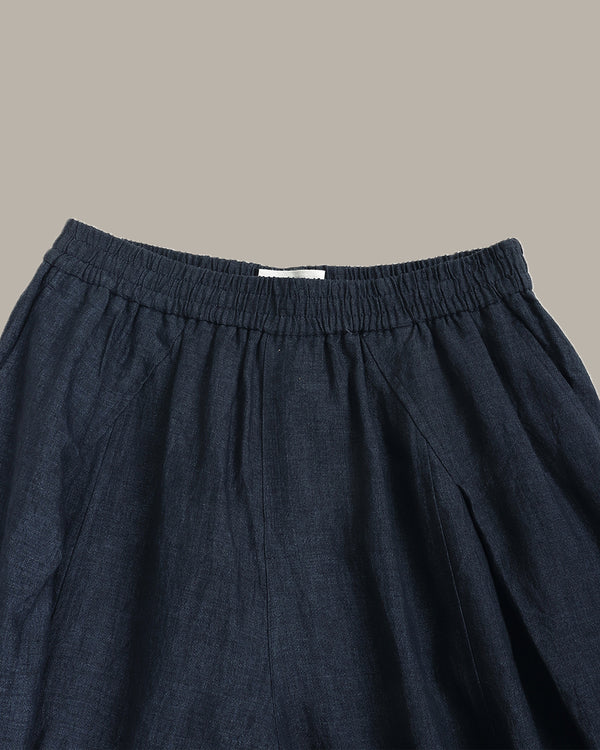 navy wide-leg pants on a light gray background