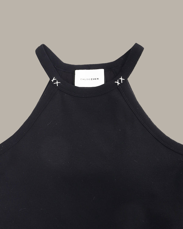 Black tank top with brand label on a gray background
