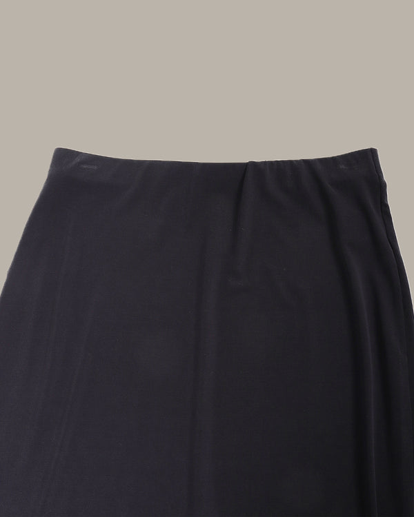 Black skirt on a beige background