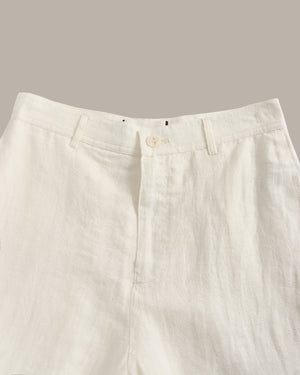 Close-up of beige pants on a neutral background
