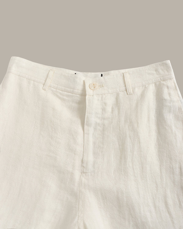Close-up of beige pants on a neutral background