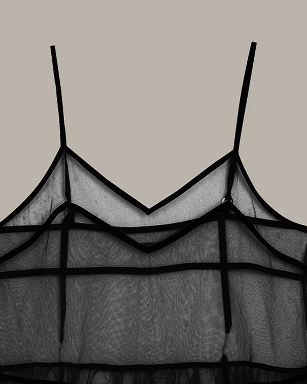 Black lace lingerie set on a beige background