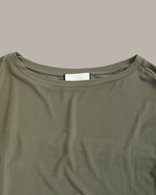 Close-up of a green shirt with a label on a gray background