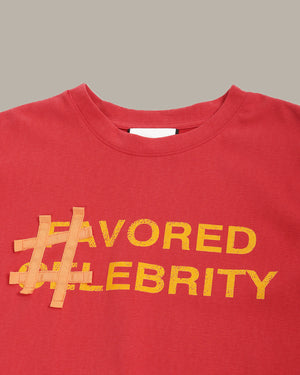 Red shirt with '#FAVORED CELEBRITY' text in yellow on a gray background