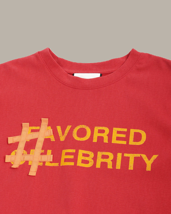 Red shirt with '#FAVORED CELEBRITY' text in yellow on a gray background