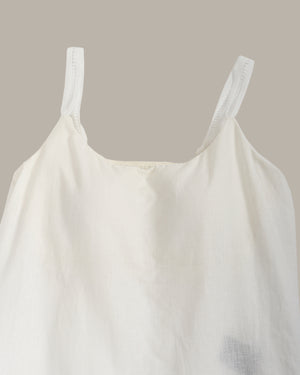 White tank top against a beige background