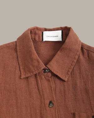 Brown shirt with collar and buttons, featuring a Chloe Chen label on a beige background