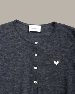 Close-up of a dark heather gray henley shirt with a white embroidered heart on the chest, featuring a button placket and a visible neck label that reads 'CLOUD QUEEN'.