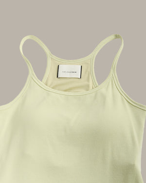 Light green tank top with thin straps on a gray background
