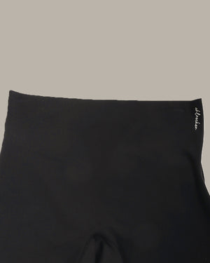 Black fabric with a brand logo on a beige background