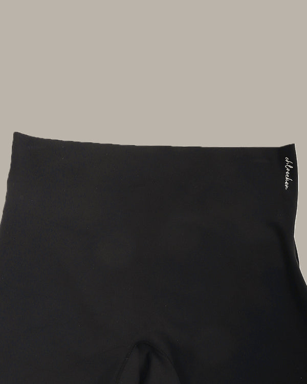 Black fabric with a brand logo on a beige background