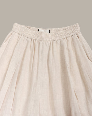 Beige pants with an elastic waistband on a neutral background