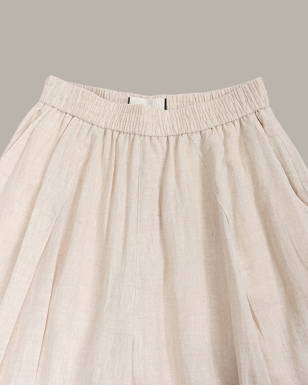 Beige pants with an elastic waistband on a neutral background