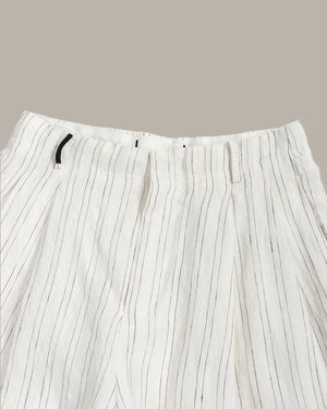 White pants with thin black stripes on a beige background