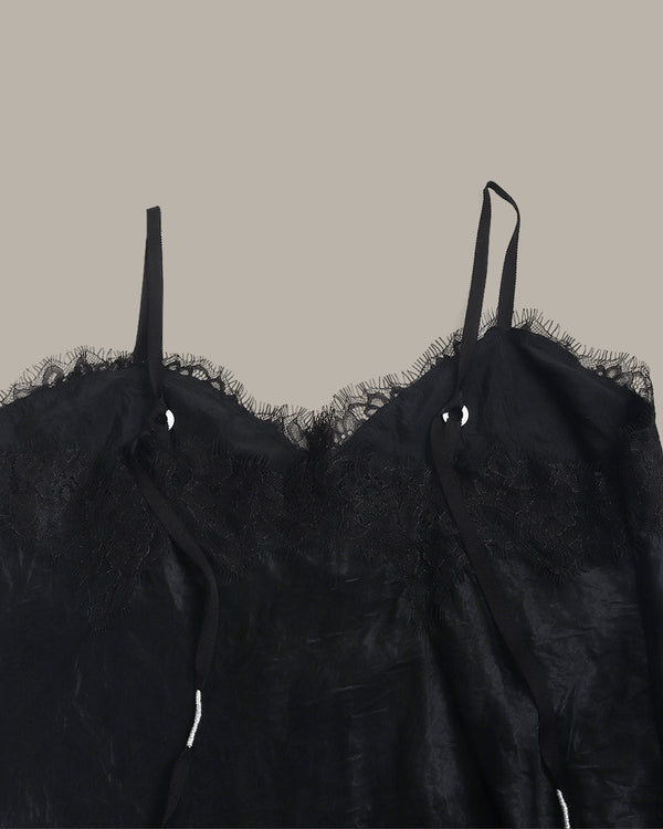 Black lace top set on a beige background