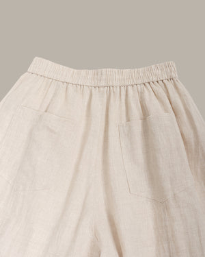 Beige pants with an elastic waistband on a neutral background