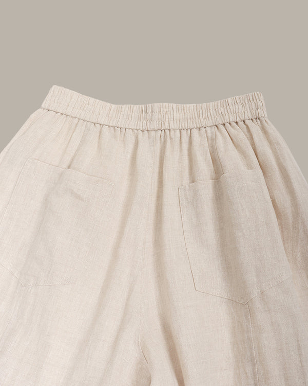Beige pants with an elastic waistband on a neutral background