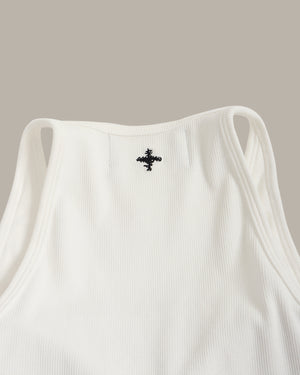 White tank top with a black logo on a beige background