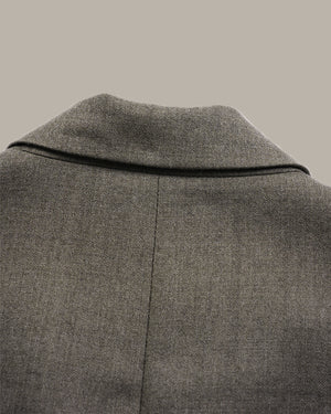 Close-up of a gray textured wool coat showing the collar and back seam against a solid neutral background.