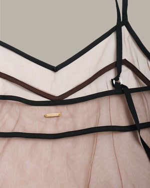 Close-up of a brown sheer mesh cami with black straps and a gold tag on a neutral background