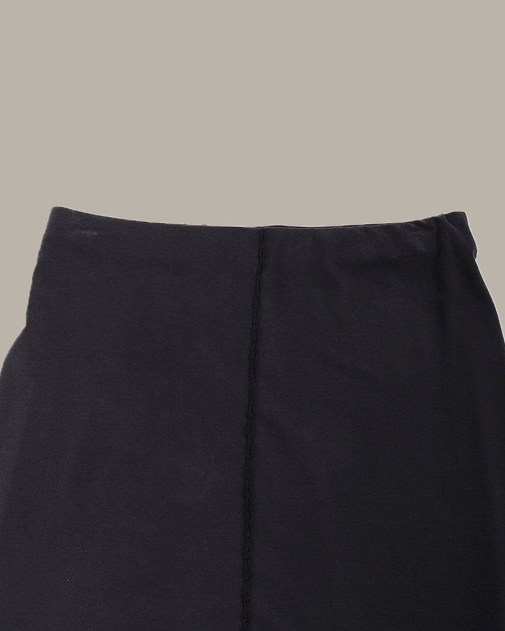 dark grey pencil skirt on a beige background