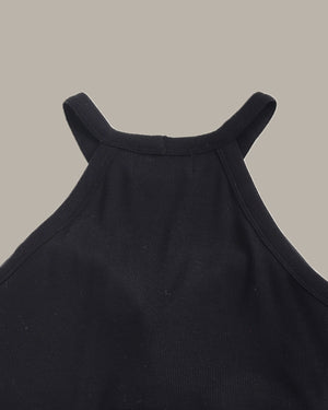 Close-up of a black sleeveless top on a beige background