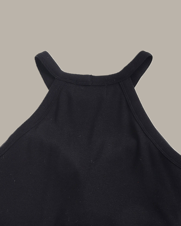 Close-up of a black sleeveless top on a beige background