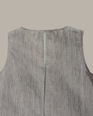 Gray sleeveless shirt with a visible seam on a light gray background