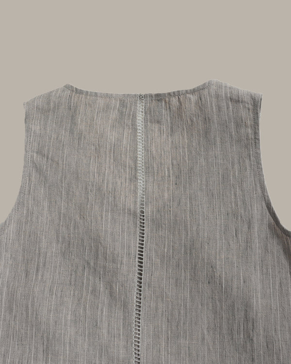 Gray sleeveless shirt with a visible seam on a light gray background