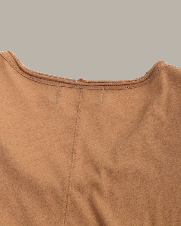 Close-up of a brown garment with a plain background