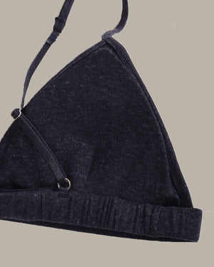 navy bra with a strap on a beige background