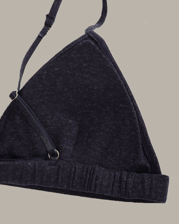 navy bra with a strap on a beige background
