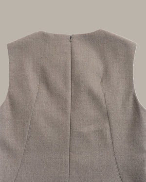 Close-up of the back of a sleeveless vest in a heathered taupe-gray fabric, showing a central seam and zipper closure against a solid neutral background.
