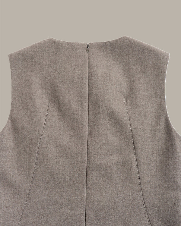 Close-up of the back of a sleeveless vest in a heathered taupe-gray fabric, showing a central seam and zipper closure against a solid neutral background.