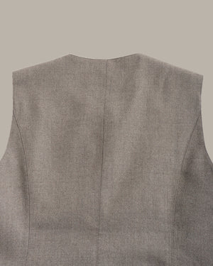Close-up of the back of a sleeveless gray vest or waistcoat, showing a fine textured fabric and a centered seam, on a plain taupe background.