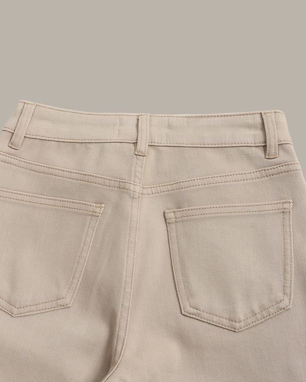 Close-up of the back waistband and rear pockets of light beige denim jeans, showing belt loops, stitching, and pocket details against a solid neutral background.