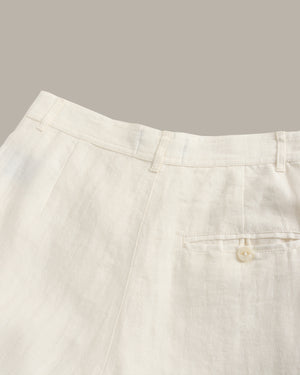 Close-up of light-colored pants with a pocket on a gray background