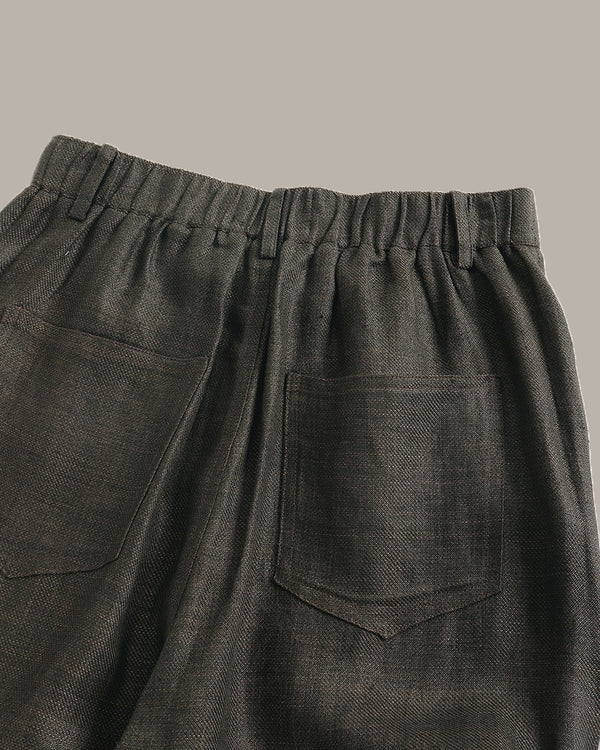 Dark gray pants with two front pockets on a neutral background