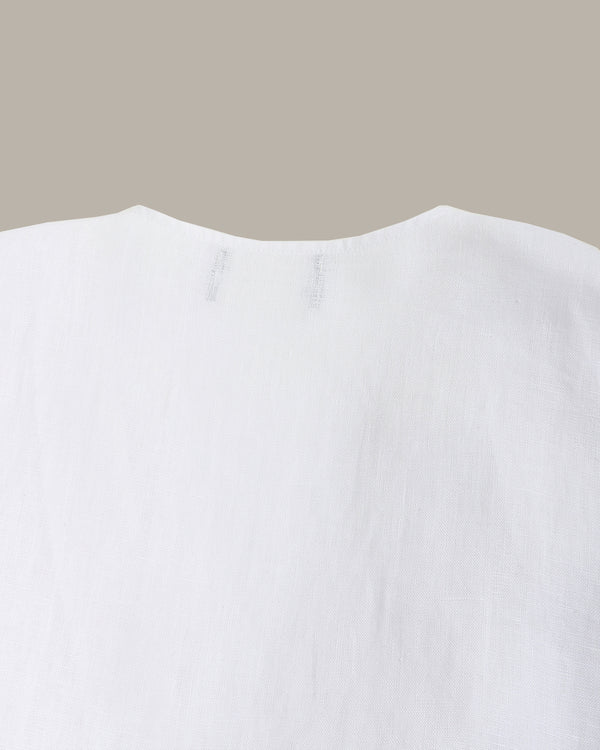 Close-up of a white garment with a neutral background