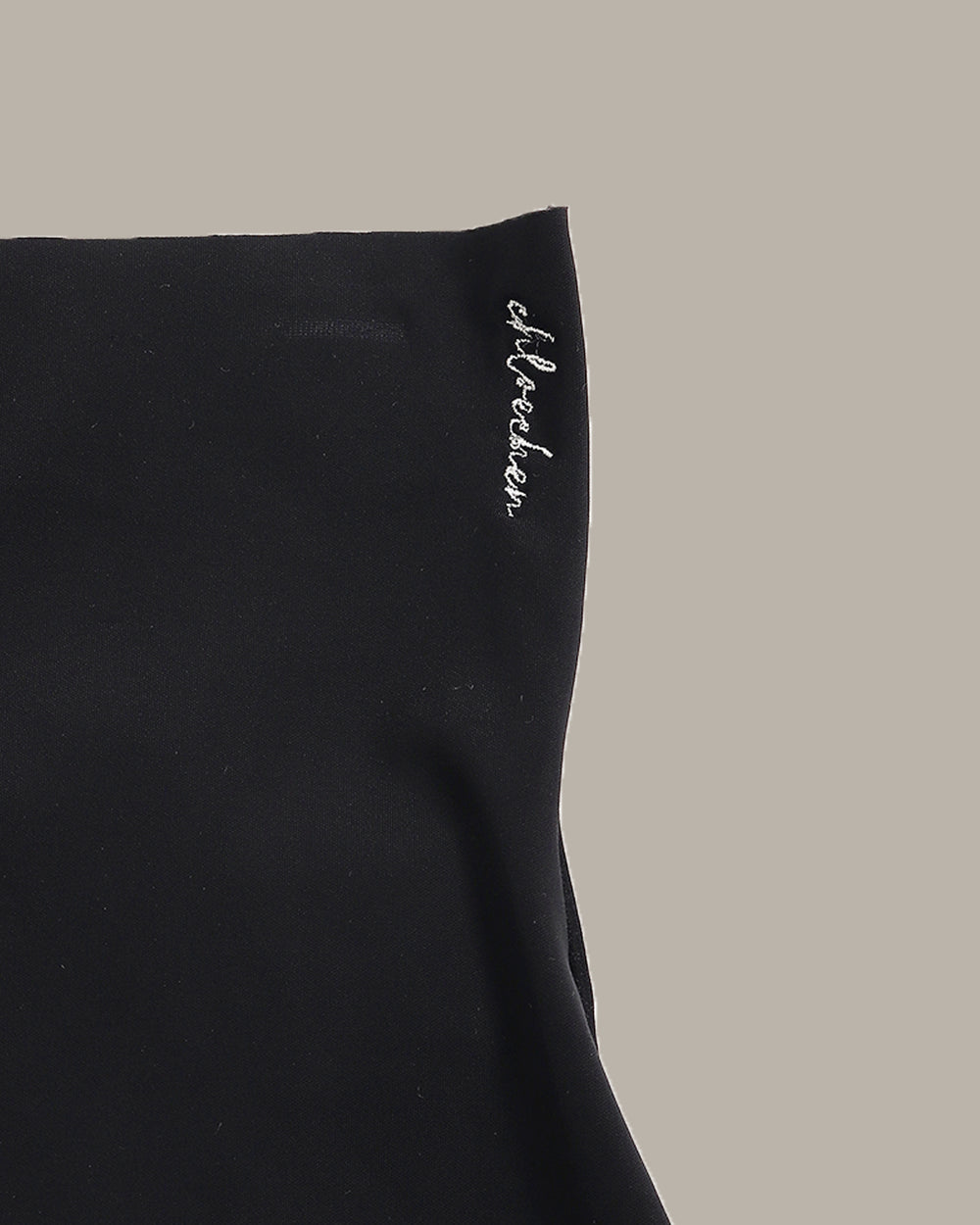 Black athletic shorts on a beige background