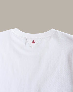White shirt with a small red logo on a beige background