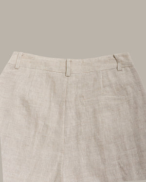 Close-up of beige pants on a neutral background