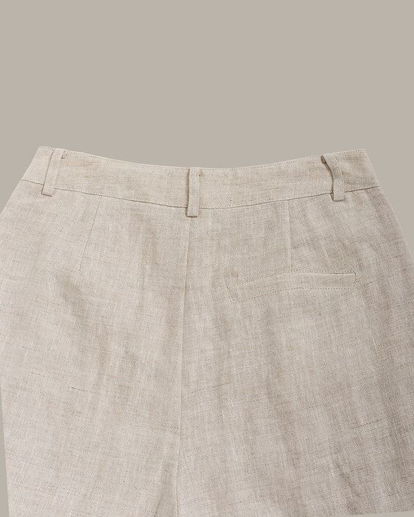 Close-up of beige pants on a neutral background