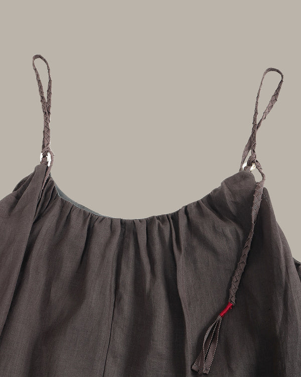 Gray dress with thin straps on a beige background