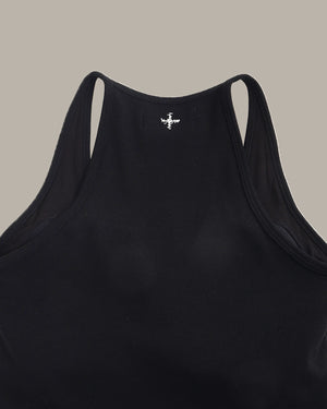 Black tank top with a small logo on the back against a beige background